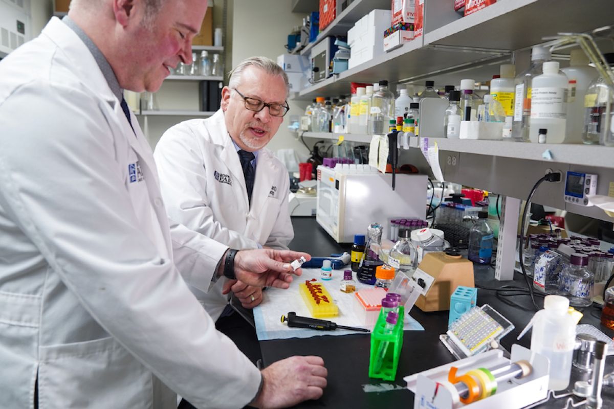 Michael Ciesielski, PhD, left, and Robert Fenstermaker, MD, co-inventors of the SurVaxM cancer treatment vaccine, in their lab at Roswell Park Comprehensive Cancer Center. 
