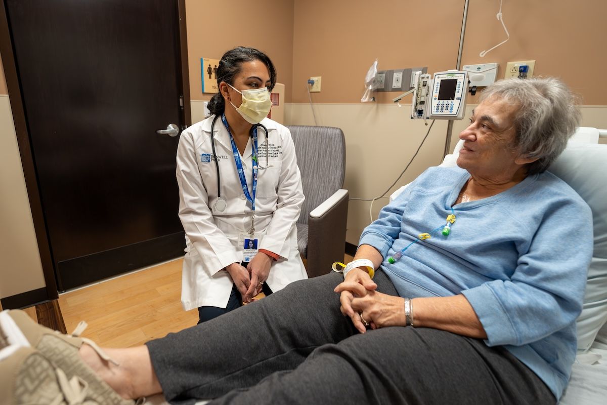 Dr. Krishnamurthy speaks with an older female patient