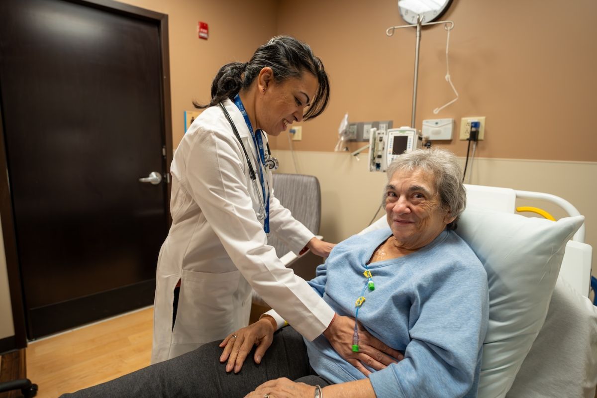 Dr. Anuradha Krishnamurthy examines an older female patient
