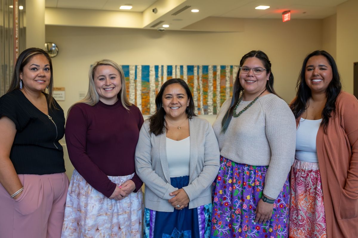 A group of women standing in the lobby of a building