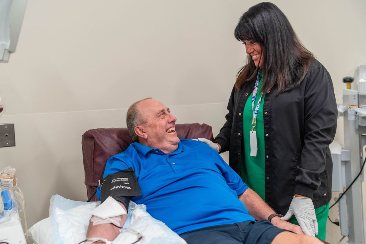 A male patient donating blood in the Donor Center is looked after by a nurse