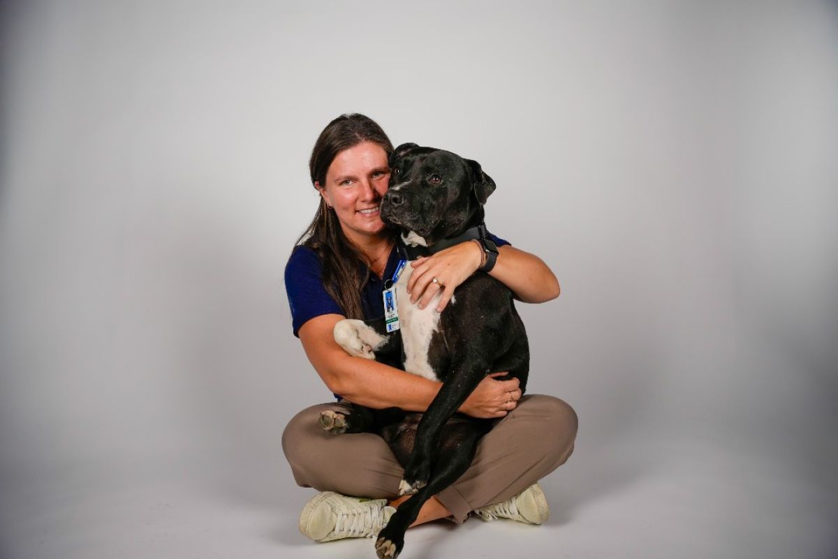 Molly Webster, RN, BSN, holds her therapy dog, Zoar. 