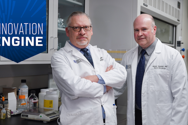 Dr. Fenstermaker and Dr. Ceisielski pose in a lab, showcasing their brain tumor vaccine SurVaxM