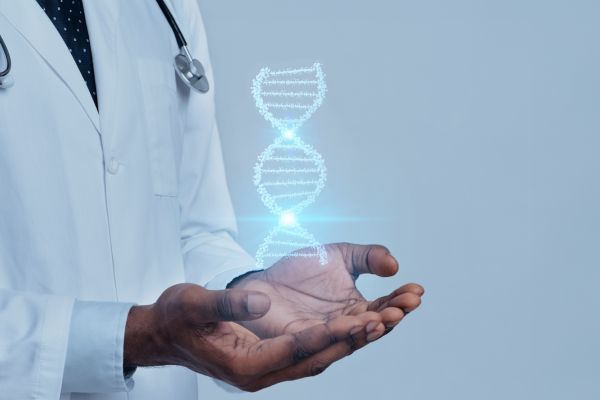 A doctor in a white jacket holds their hands out with a DNA strand floating in them