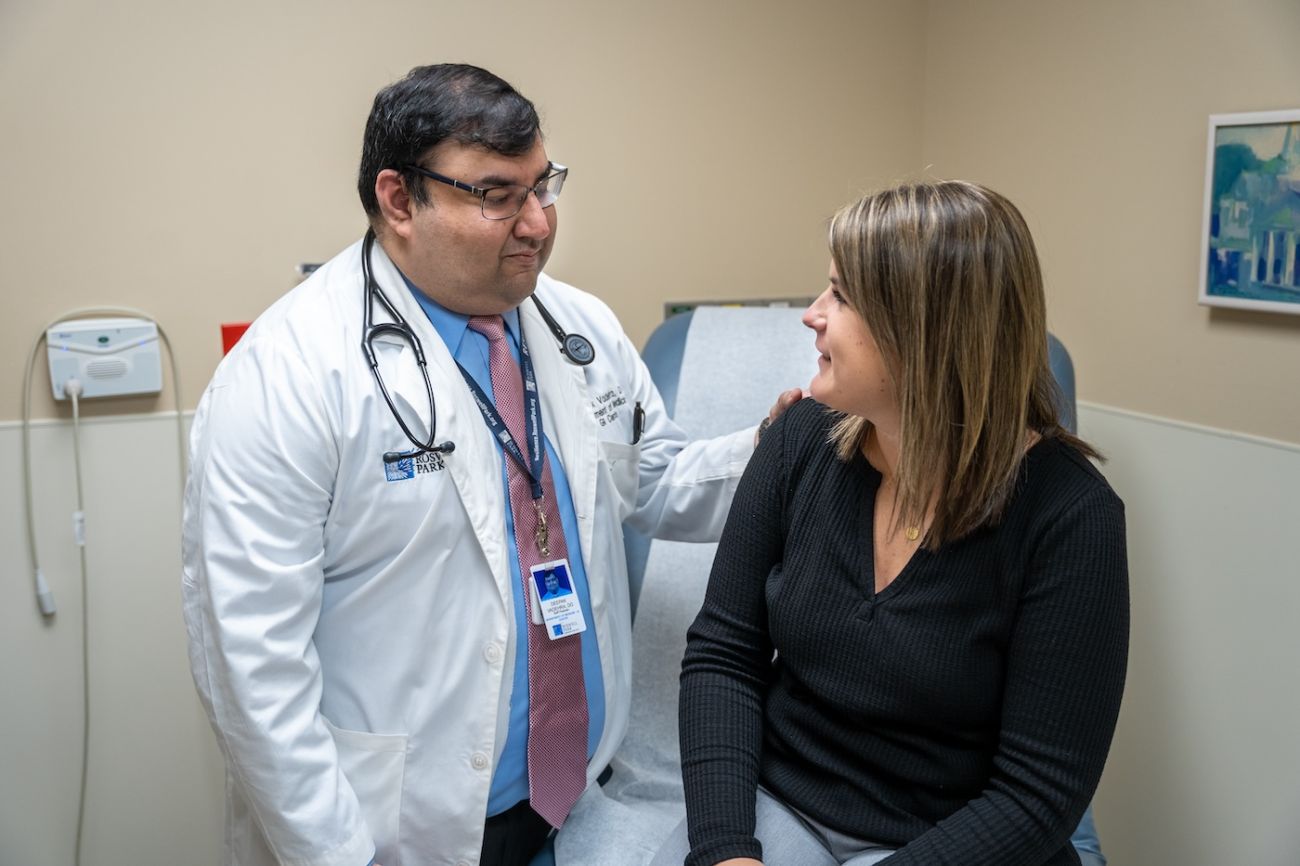 Dr. Deepak Vadehra consults a female patient in clinic