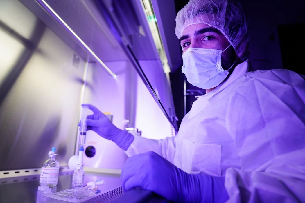 Man filling a test tube at the bench