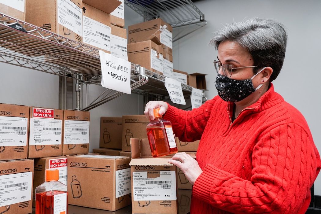 Woman filling a box with medical supplies